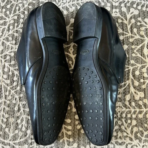 Tod’s black buckle loafers